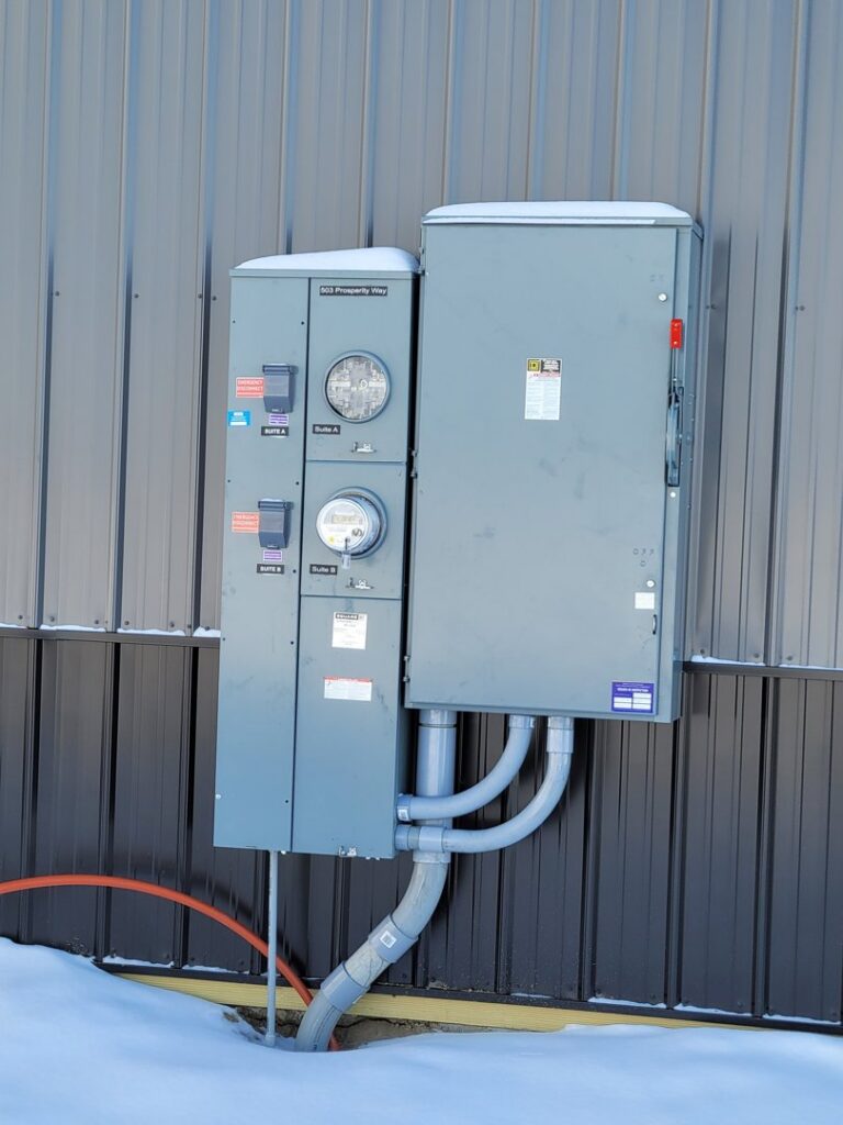 Commercial electrical meters and service boxes on a building by FOXX & Hounds Electric in Sioux City, IA.