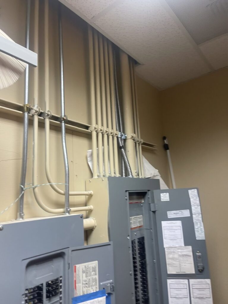 Commercial electrical panels and conduit runs installed on a wall by Gold Electric INC in Bend, OR.