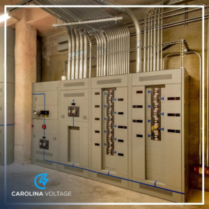 A large commercial electrical panel with multiple conduits, demonstrating expert electrical installation by Carolina Voltage in Charlotte, NC.