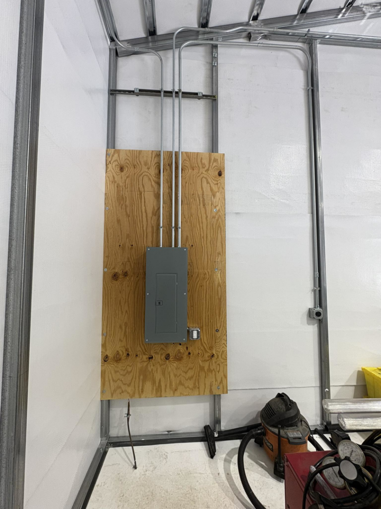 A new electrical panel installation with conduits in a commercial building by East West Electric LLC in Chester, NH.