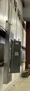 Commercial electrical panels and conduit installation on a wall by Electrician Near Me in Broken Arrow, OK.