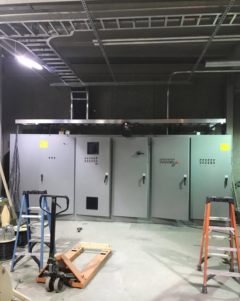 Large commercial electrical panels and cable trays installed by Progressive Electrical Services, Inc. in Lee, NH.