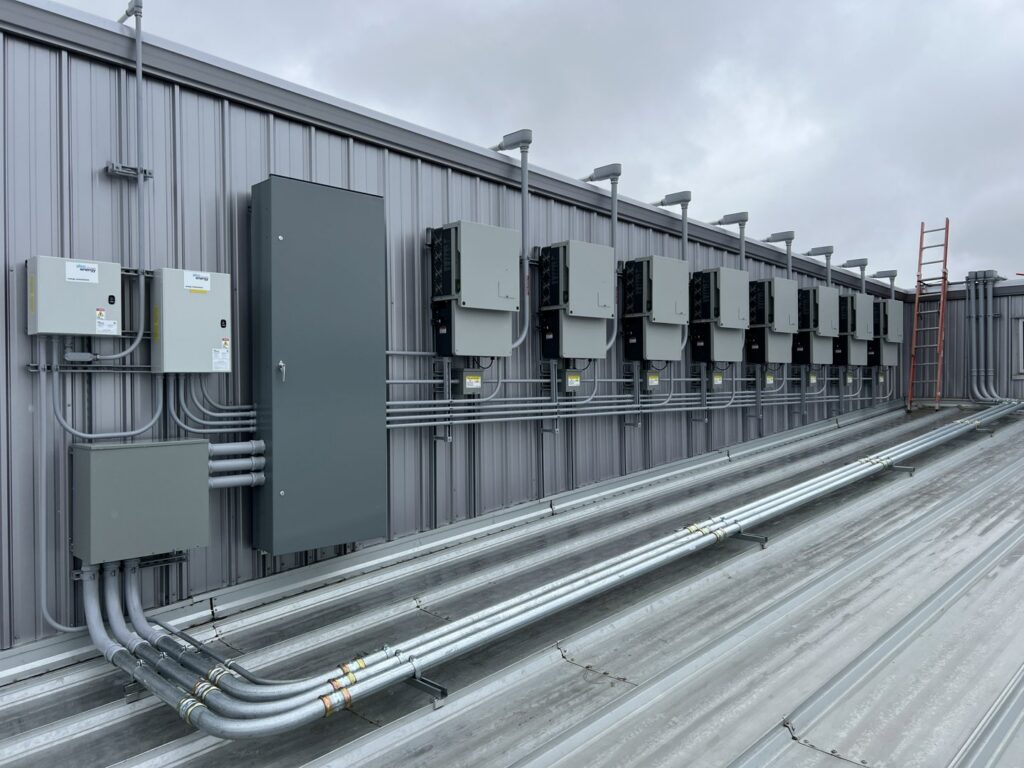 Commercial electrical panels and conduit installed on a building exterior by Sparrow Electric, LLC in Denver, CO.