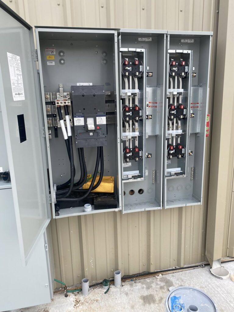 Multiple commercial electrical panels with conduits and wiring installed by Camo Construction & Electric in Lake Charles, LA.