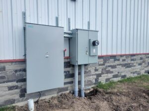 Commercial electrical panels and conduit installed on the exterior of a building by 4G Electrician in Dallas, TX