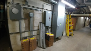 Multiple commercial electrical panels and conduit installed in a utility room by Triumph Electrical Services, Inc in Minneapolis, MN