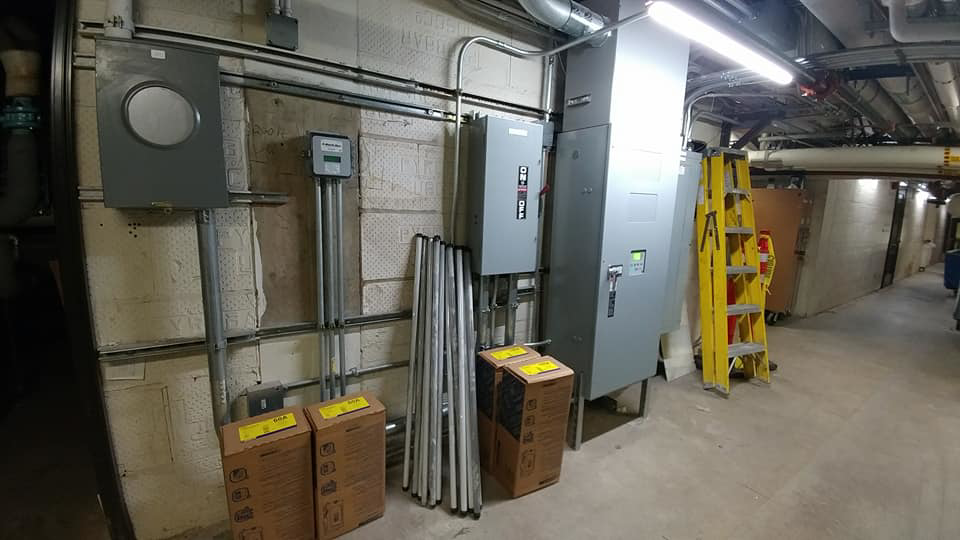Multiple commercial electrical panels and conduit installed in a utility room by Triumph Electrical Services, Inc in Minneapolis, MN