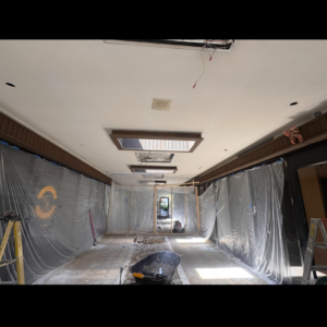 Commercial electrical renovation in progress with exposed wiring and plastic sheeting in a hallway by Mechatronics LLC in Memphis, TN.