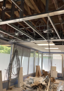Commercial electrical renovation with exposed wiring and ceiling grid by Pacific Sun Electric in Oregon City, OR