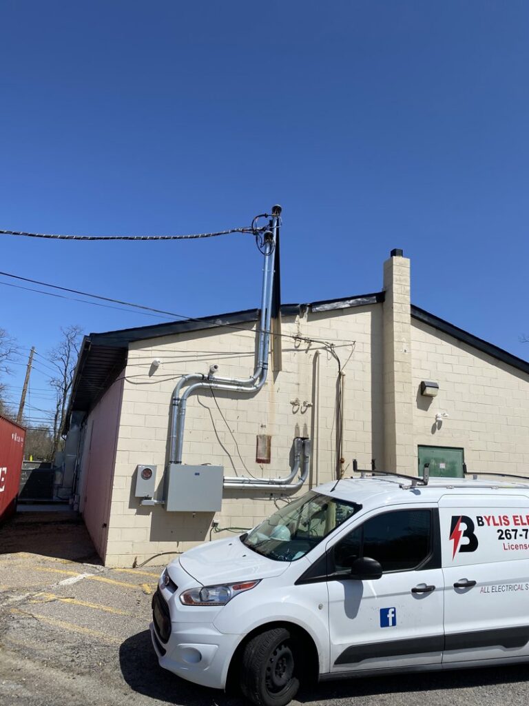 New commercial electrical service mast and conduit installation on a building exterior by BYLIS Electric LLC in Allentown, PA.