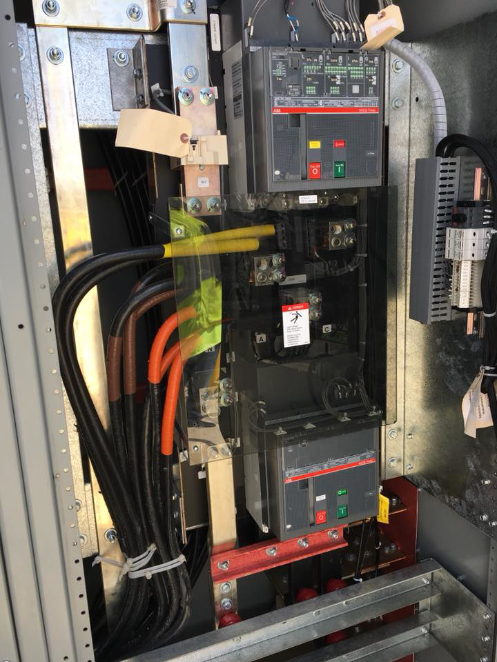 A close-up view inside a commercial electrical switchgear showing heavy-gauge wiring and circuit breakers installed by Mcgehee Electric, LLC in Montgomery, AL.