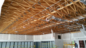 Commercial electrical wiring and conduit installation in a large room under construction by Ready Electric 24/7 in Knoxville, TN.