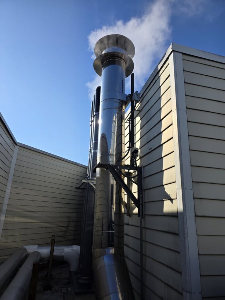 A large commercial exhaust stack system on a building, installed by Clean Air Quality Service Inc in Hawthorne, NY