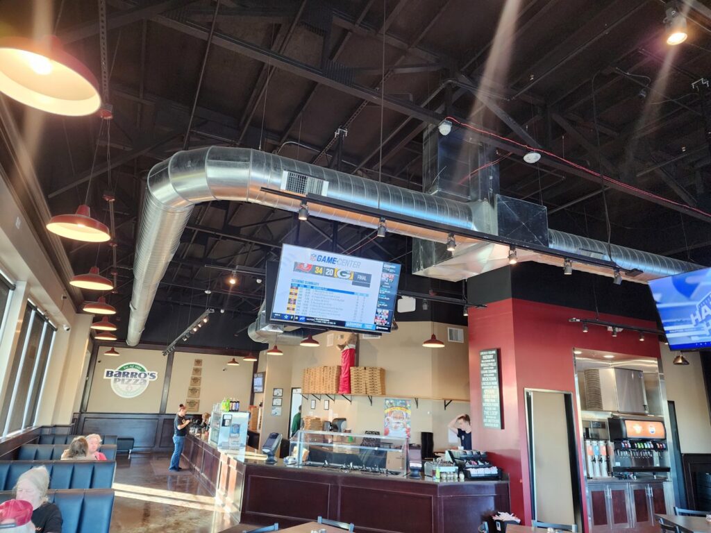 Exposed spiral ductwork and air vents installed in a commercial building, showcasing HVAC work by State 48 Home Comfort LLC in Peoria, AZ.