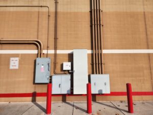 Exterior view of commercial electrical panels and conduits installed on a building wall by York Electrical Services in York, PA.