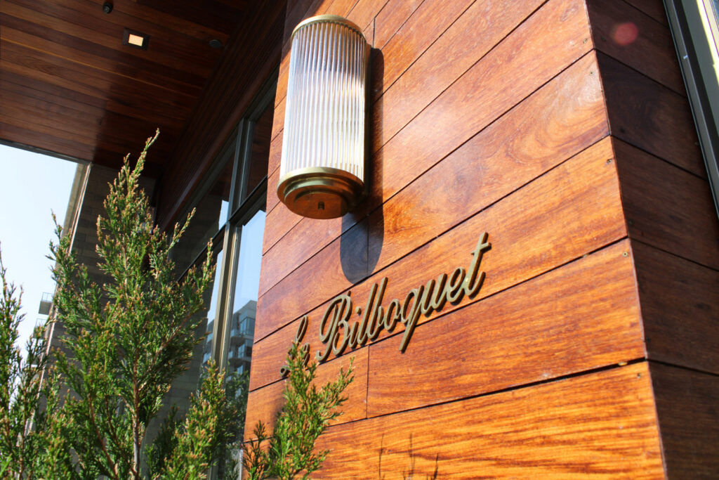 A stylish commercial exterior wall sconce installed by ACJ Electric LLC in North Babylon, NY, illuminating a building facade.