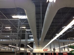 Large fabric ductwork installed in the ceiling of a commercial building, a project completed by ACI Northwest Heating, Cooling & Electrical in Dalton Gardens, ID.