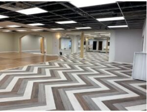 Commercial space with wood-look chevron flooring installed by Carpet Planet LLC in Colorado Springs, CO.