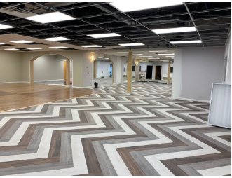 Commercial space with wood-look chevron flooring installed by Carpet Planet LLC in Colorado Springs, CO.