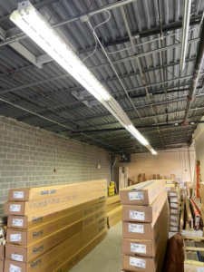 Commercial fluorescent lighting fixtures installed in a warehouse or industrial space by K E Troutman Electrical Contractor in Newark, DE.
