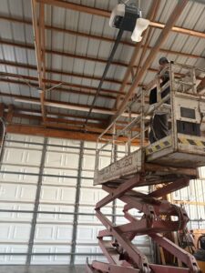 A commercial garage door with frosted glass panels installed on a brick building by Ozarks Overhead Door & More in Springfield, MO.