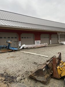 Multiple beige garage doors installed on a commercial building under construction by Garage Door Repair Company, LLC in Pueblo, CO.
