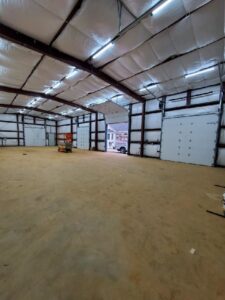 Multiple commercial garage doors installed in a large building by Door Serv Pro in Inwood, WV.