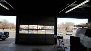 Interior view of a commercial garage door, partially open, installed by Smith's Garage Door in Clarksville, TN.