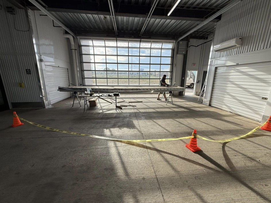 A technician working on a commercial garage door installation or repair at Guest Garage Door Company in Lexington, KY.