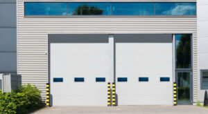 Two white commercial garage doors installed by Revolution Garage Door, LLC in Corvallis, OR.