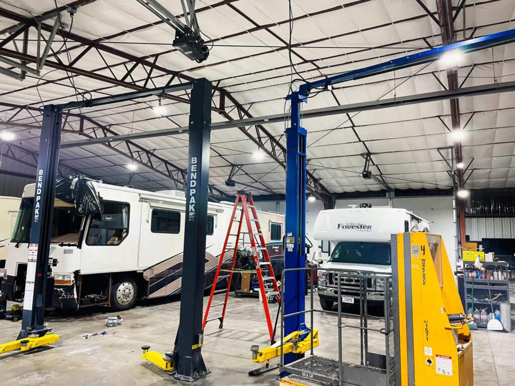 A commercial garage with new overhead lighting installed by Tier 1 Electric, enhancing visibility in Boise, ID.