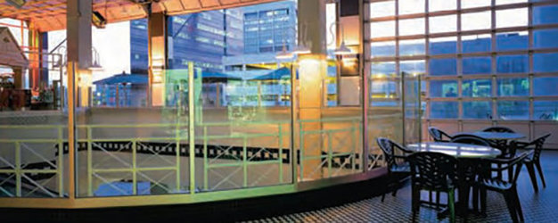 Interior view of a commercial space featuring large glass panel garage doors by Overhead Door Company of Knoxville in Knoxville, TN