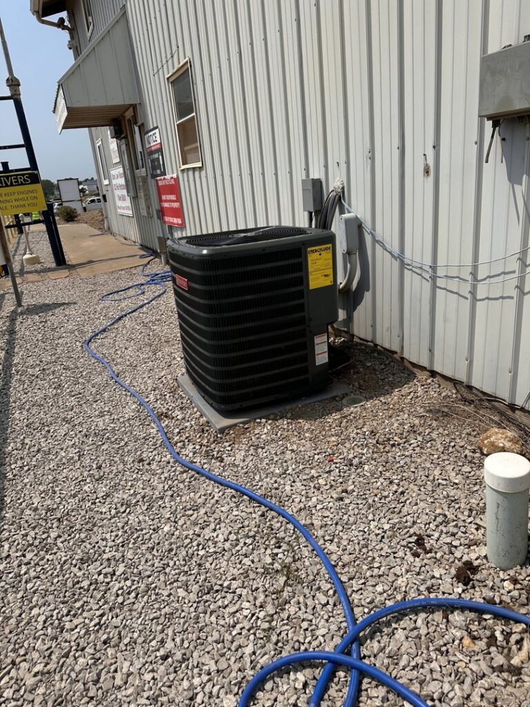 A commercial Goodman air conditioning unit installed outside a building by Integrity Aire in St. Charles, MO.