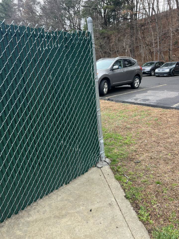 A long section of commercial green chain-link fence installed by Oxford Fence Company in Oxford, CT.