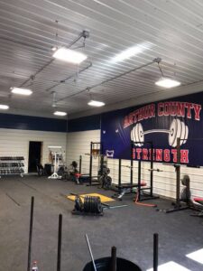 Commercial gym with exposed conduit and industrial lighting installed by Highmark Electric in Kearney, NE.