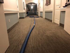 A long commercial hallway carpet being cleaned with professional equipment by Martin Pro Cleaner in Tulsa, OK