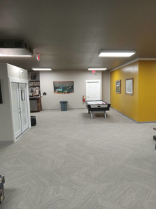 Long commercial hallway featuring new carpet tile installation by Abbey Carpet and Flooring of Kalispell, MT