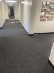 A newly installed dark grey carpet in a commercial hallway by Carpet Cabin in Fort Smith, AR.