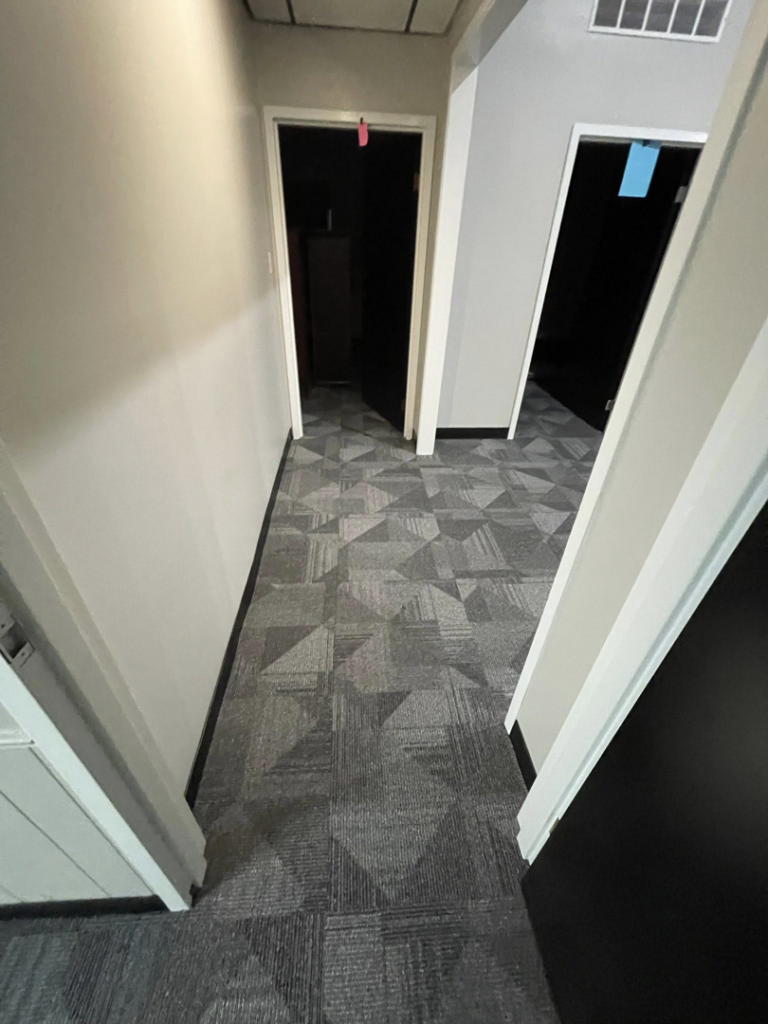 Patterned commercial carpet tiles installed in a hallway by A Step Above Flooring in Lexington, KY