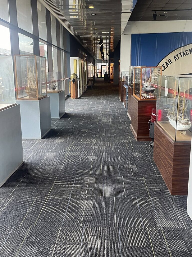 A commercial hallway featuring patterned carpet tiles installed by Carpet World Baton Rouge, LA.