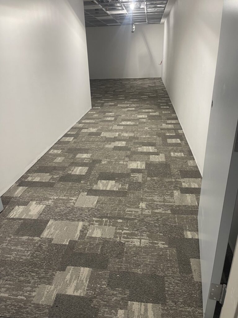 Commercial hallway with new carpet tiles installed by Mendez Carpet in Grand Rapids, MI.