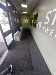A newly installed dark grey carpet in a commercial hallway by Bonsai Flooring in Spanish Fork, UT.