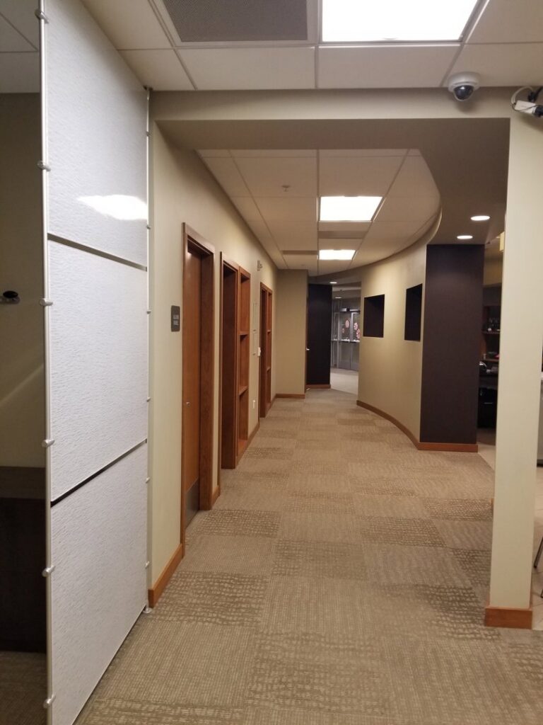 A commercial hallway showcasing a new patterned carpet installation by Heather Mountain Flooring in Layton, UT.