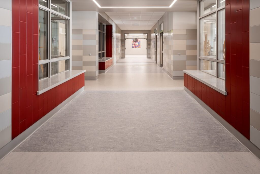 A clean commercial hallway featuring light-colored vinyl flooring installed by Capital Carpet & Flooring Specialists in Wilmington, MA