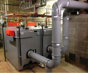 A commercial heating system with boilers and extensive piping, installed by Accurate Air Inc. in Manchester, NH.