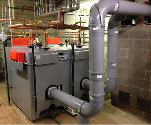 A commercial heating system with boilers and extensive piping, installed by Accurate Air Inc. in Manchester, NH.