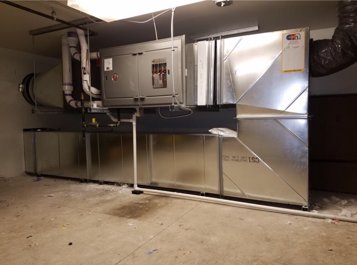 Commercial HVAC air handler unit with extensive ductwork installed by Central Heating & Air in Sioux Falls, SD