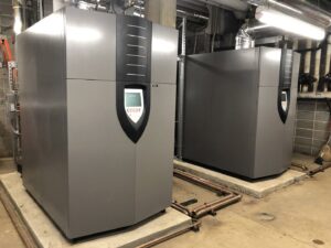 Two large commercial HVAC boilers installed in a mechanical room by Jaco Sales, Inc. in Little Rock, AR.