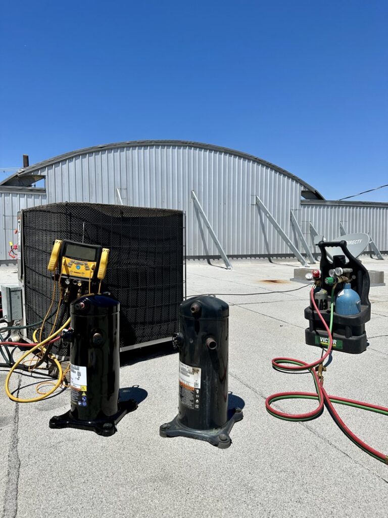 Commercial rooftop HVAC unit with new compressors and diagnostic tools, indicating a repair by Texas Air & Heat in Arlington, TX.