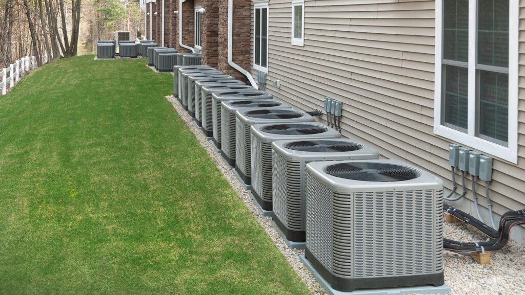 A row of commercial HVAC condenser units installed outside a building, representing services by Love HVAC LLC in Bluffton, SC.